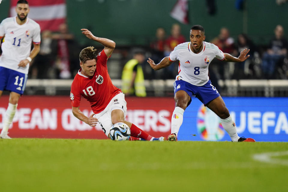 Austria's Alexander Prass, left, and Belgium's Youri Tielemans view for the ball during the Euro 2024 group F qualifying soccer match between Austria and Belgium at the Ernst Happel stadium in Vienna, Austria, Friday, Oct. 13, 2023. (AP Photo/Florian Schroetter)