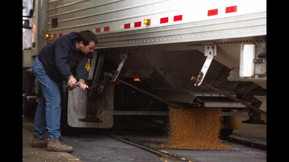 Colin Kruse cranks a lever to open up his transport truck and drop corn into a collection pit on Friday, Dec. 22, 2023, at Cargill, Inc.’s facility in East St. Louis. For the third time in five years, the U.S. will import more agricultural products than it exports. However, this year’s deficit is tracking to be around $20 billion, far more than last year’s $2 billion deficit.