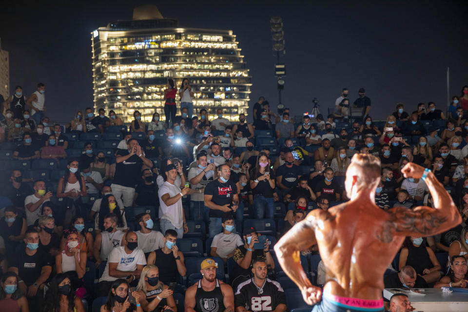 A contestant participates in the final round during the National Amateur Body Builders Association competition in Tel Aviv, Israel, Wednesday, Aug. 19, 2020. Because of the coronavirus pandemic, this year's competition was staged outdoors in Tel Aviv. The 85 participants were required to don protective masks in line with health codes. (AP Photo/Oded Balilty)