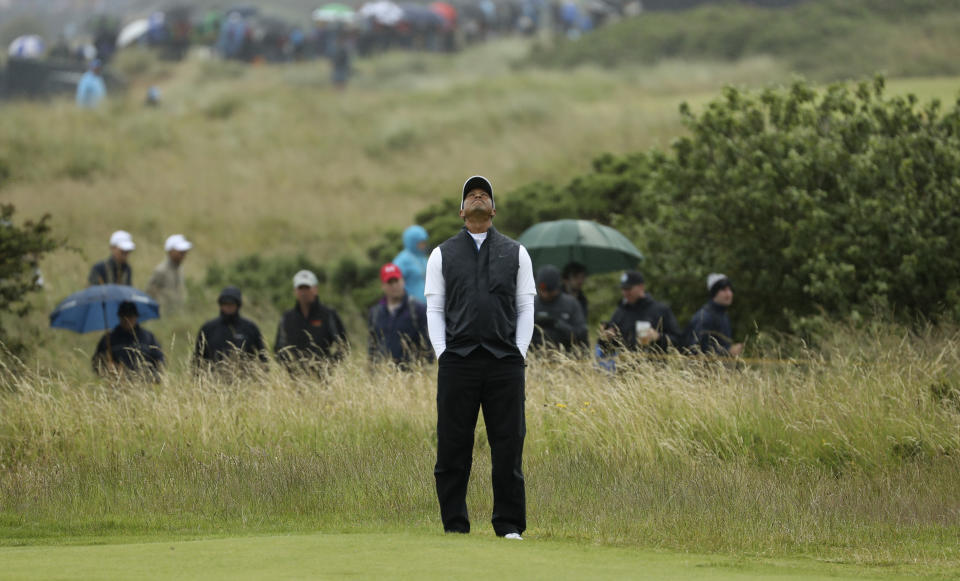 Tiger Woods of the United States looks skyward as he wait to play on the 17th green during the second round of the British Open Golf Championships at Royal Portrush in Northern Ireland, Friday, July 19, 2019.(AP Photo/Peter Morrison)