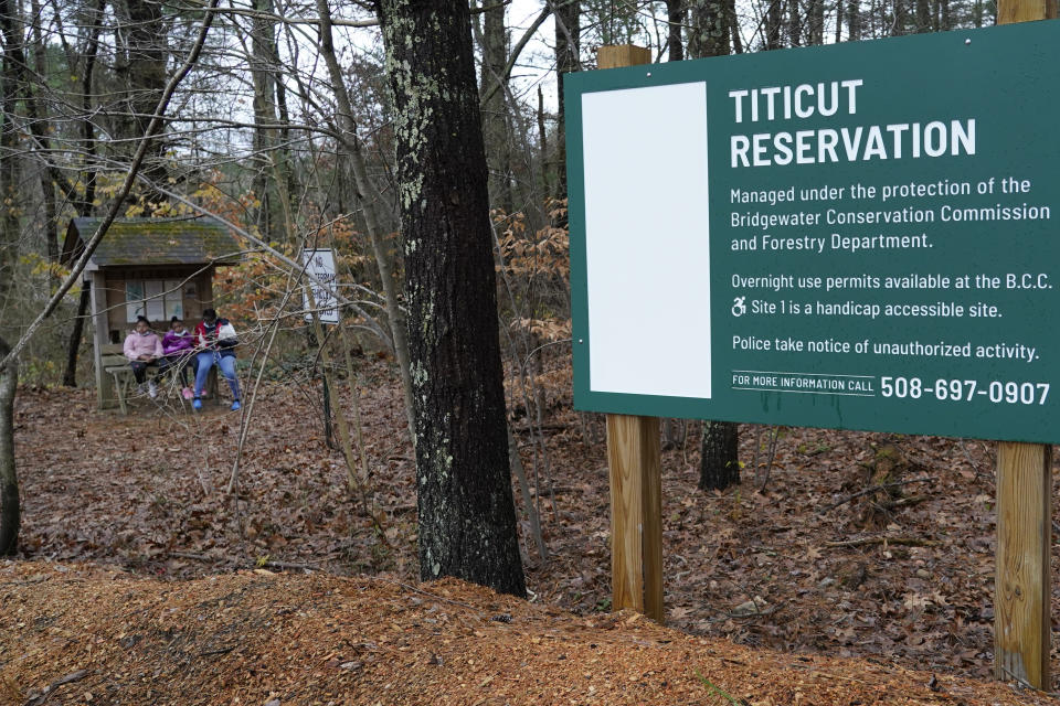 Mattakeeset Massachuset tribal members, left, sit at the entrance of Titicut Indian Reservation, Friday, Nov. 27, 2020, in Bridgewater, Mass. A rift has been widening between Native American groups in New England over a federal reservation south of Boston where one tribe is planning to build a $1 billion casino. The Mattakeeset Massachuset tribe contend the Mashpee Wampanoag tribe doesn't have exclusive claim to the lands under their planned First Light casino in the city of Taunton, as they've argued for years. (AP Photo/Elise Amendola)