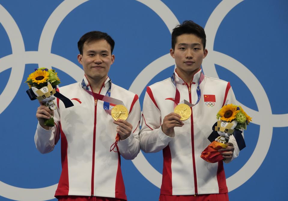 Wang Zongyuan and Xie Siyi of China pose for photo after winning gold medals during the men's Synchronized 3m Springboard Final at the Tokyo Aquatics Centre at the 2020 Summer Olympics, Wednesday, July 28, 2021, in Tokyo, Japan. (AP Photo/Dmitri Lovetsky)