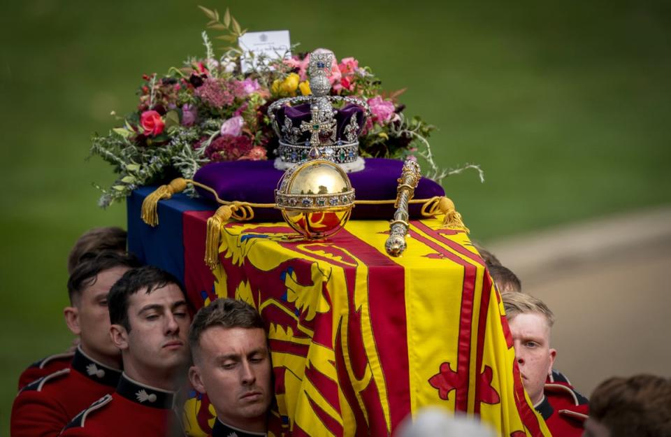 The bearer party carry the coffin of Queen Elizabeth II, draped in the Royal Standard with the Imperial State Crown and the Sovereign’s orb and sceptre, to the state herse for its journey to Windsor Castle following her State Funeral at Westminster Abbey, London (Jane Barlow/PA) (PA Wire)