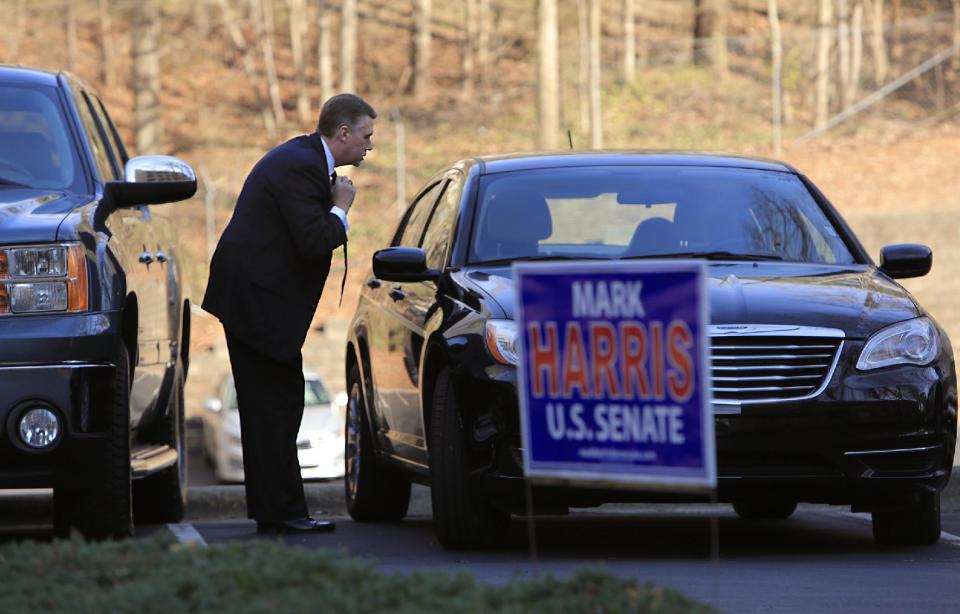 FILE - In this March 14, 2014 file photo, Rev. Mark Harris, who is seeking a Republican U.S. Senate nomination in the upcoming North Carolina primary, ties his tie before his campaign event in Raleigh, N.C., (AP Photo/Ted Richardson)