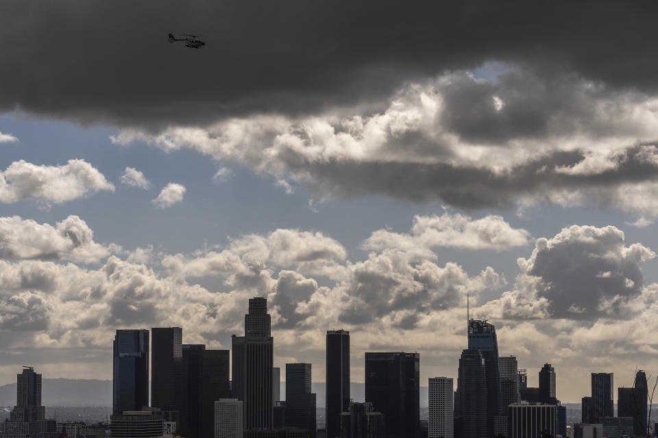 Clouds move over the Los Angeles skyline, Thursday, Feb. 8, 2024. Skies have cleared over most of California after days of wind, rain and heavy snowfall that caused power outages, street flooding and damaging mudslides. (AP Photo/Damian Dovarganes)