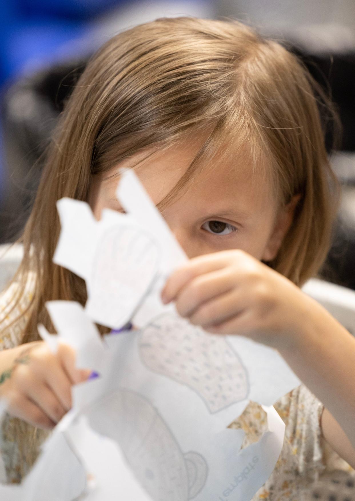 Layla Watson, 6, cuts pieces out to make a sea otter puppet at the Massillon Public Library's summer reading kickoff on Monday. This year's theme is "Oceans of Possibilities." Reading programs are available to readers across Stark County. 
(Photo: Kevin Whitlock / Massillon Independent)