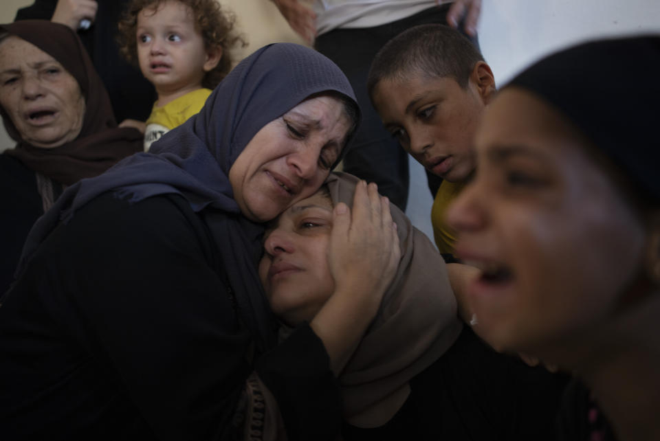 FILE - Relatives mourn the death of Palestinian teenager, Iyad al-Rabiel, 14, who was shot and killed by Israeli troops during a protest along the Gaza Strip's border with Israel, in the family home during his funeral in Gaza City, Saturday, Sept. 7, 2019. Rights groups said Thursday. Dec. 2, 2021, that Israel failed to investigate shootings that killed more than 200 Palestinians and wounded thousands at violent protests along the Gaza frontier in recent years, strengthening the case for the International Criminal Court to intervene. (AP Photo/Khalil Hamra, File)