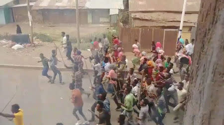 Demonstrators walk along a street in Asella, Oromiya Province, Ethiopia February 13, 2018, in this still image taken from a social media video. Mandatory Credit. TWITTER/@WAGUWAGU91 via REUTERS