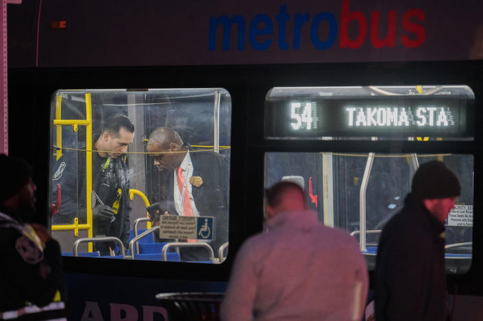 Police investigators search a bus following a shooting that occurred on it in January in Washington, D.C. 