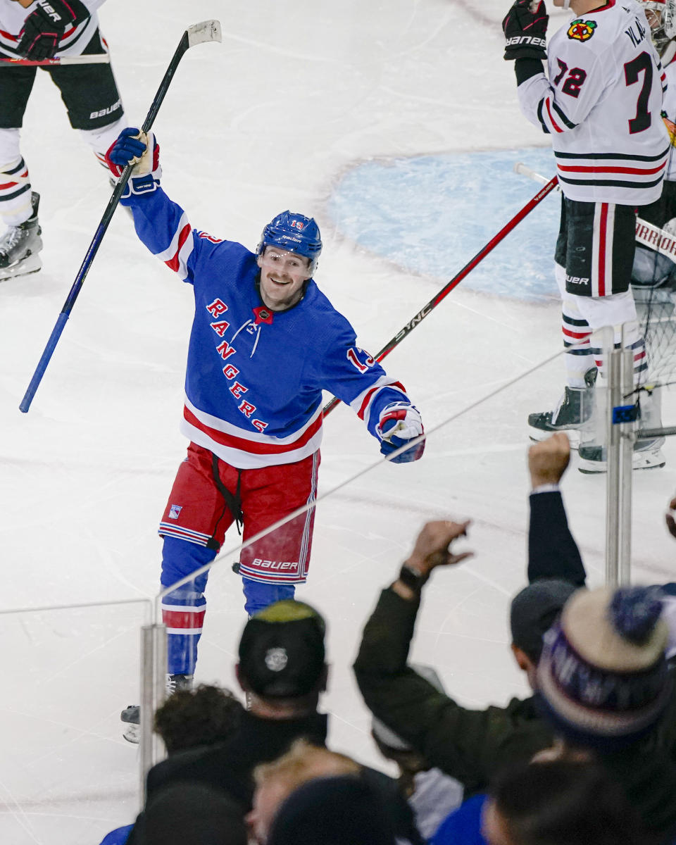 New York Rangers left wing Alexis Lafreniere, center, celebrates after his team scored during the third period of an NHL hockey game against the Chicago Blackhawks in New York, Thursday, Jan. 4, 2024. (AP Photo/Peter K. Afriyie)