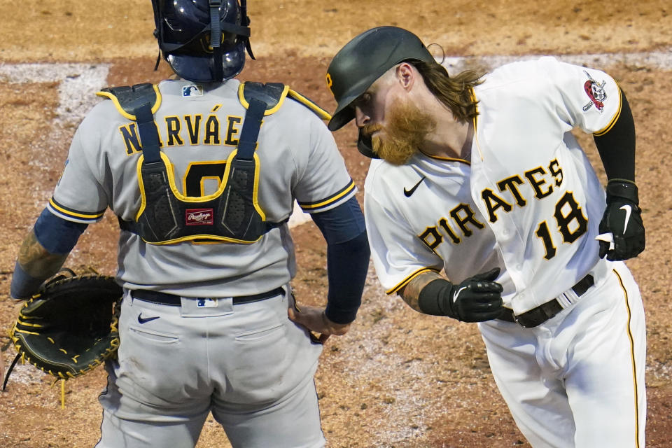 Pittsburgh Pirates' Ben Gamel (18) heads back to the dugout past Milwaukee Brewers catcher Omar Narvaez after hitting a solo home run during the fifth inning of a baseball game in Pittsburgh, Thursday, July 1, 2021. (AP Photo/Gene J. Puskar)