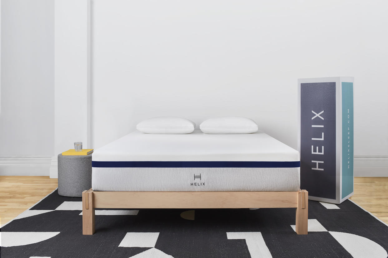  A Helix midnight mattress in a bedroom next to a box 