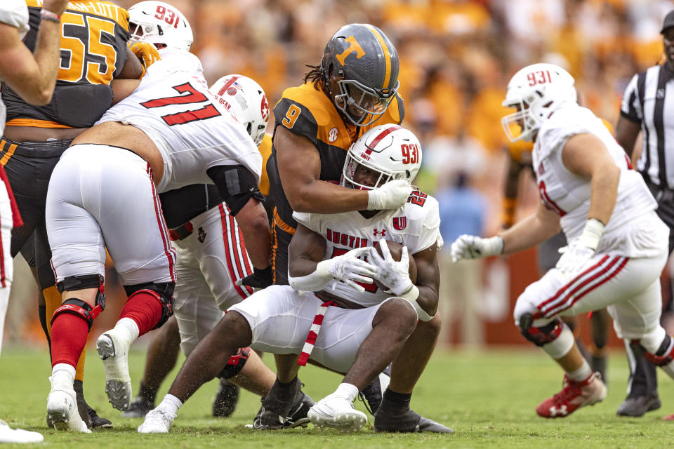 Austin Peay running back Jevon Jackson (22) is tackled by Tennessee defensive lineman Tyler Baron (9) during the first half of an NCAA college football game Saturday, Sept. 9, 2023, in Knoxville, Tenn. (AP Photo/Wade Payne)