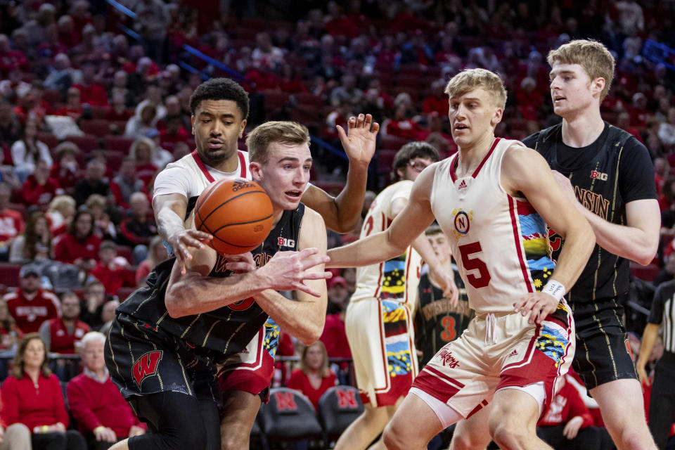 Nebraska's Jamarques Lawrence (10) knocks the ball away from Wisconsin's Tyler Wahl (5) in the second half during an NCAA college basketball game Saturday, Feb. 11, 2023, in Lincoln, Neb. (AP Photo/John Peterson)