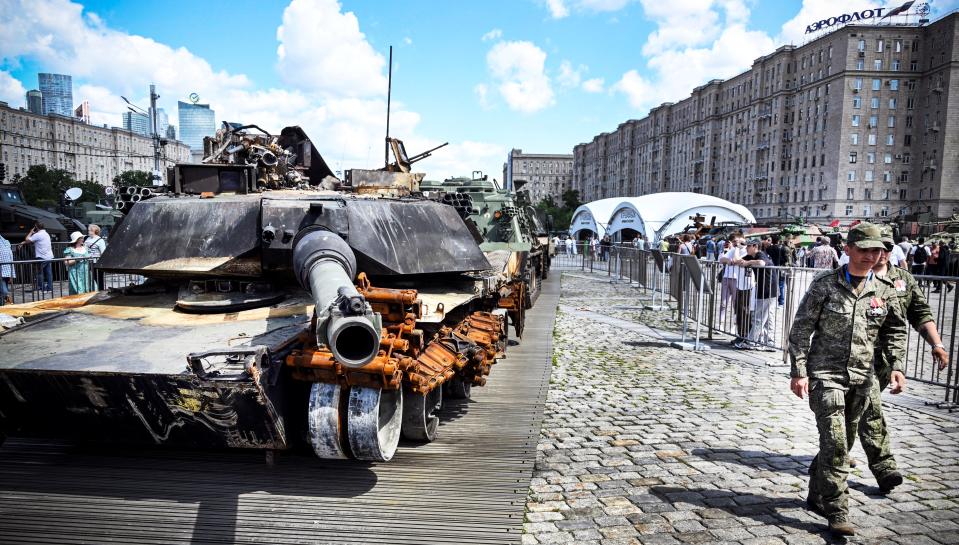 Russian servicemen walk past a US-made Abrams tank that was captured by Russian forces in Ukraine and put on display in western Moscow on June 27.