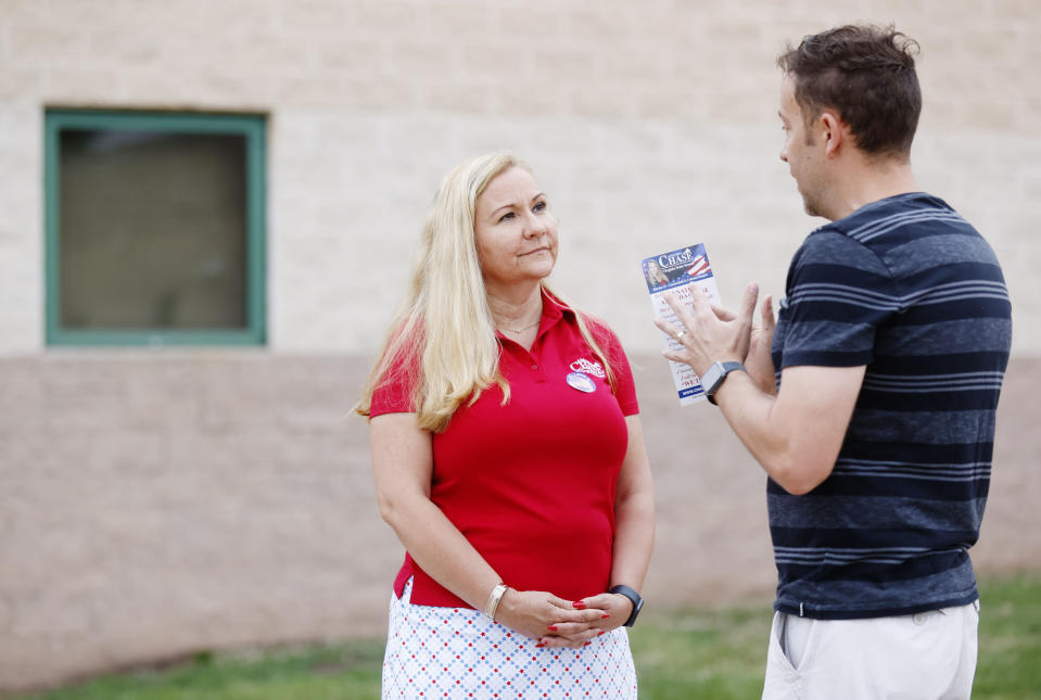 Virginia State Sen. Amanda Chase talks to voter Jason Sitterson outside Bailey Bridge Middle School in Midlothian, Va, on Tuesday, June 20, 2023. Virginia voters are set to choose their party’s nominees in a primary election Tuesday, that features dozens of state legislative races, many of them hotly contested. (Margo Wagner/Richmond Times-Dispatch via AP)