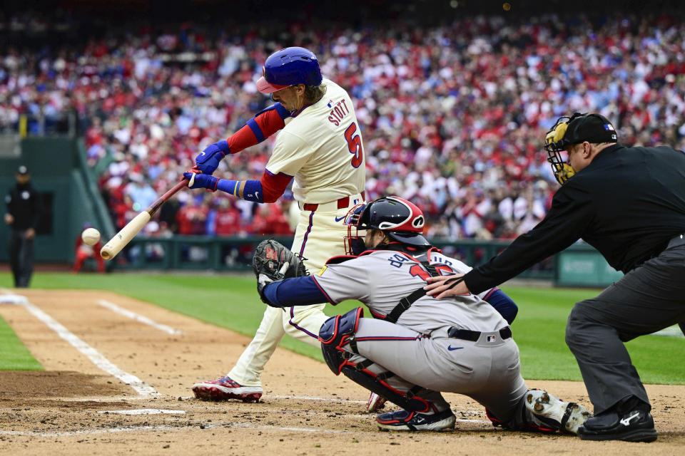 Philadelphia Phillies' Bryson Stott (5) hits a two-run single off Atlanta Braves starting pitcher Max Fried during the first inning of a baseball game, Saturday, March 30, 2024, in Philadelphia. (AP Photo/Derik Hamilton)