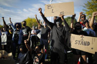 FILE - In this June 5, 2020, file photo protesters hold their fists in the air during a rally in Las Vegas against police brutality sparked by the death of George Floyd. Black people are facing a combination of stressors hitting simultaneously: isolation during the pandemic, a shortage of mental health care providers and racial trauma inflicted by repeated police killings of Black people. Black people suffer disproportionately from COVID-19 and have seen soaring rates in youth suicide attempts. (AP Photo/John Locher, File)