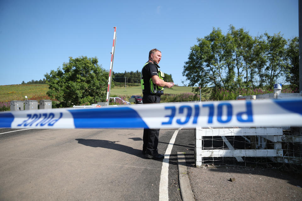 A police officer at a cordon at Carmont crossing, south of the scene in Stonehaven, Aberdeenshire, where the 06.38 Aberdeen to Stonehaven ScotRail train derailed at about 9.40am this morning. The fire service, police and ambulance service are in attendance and the incident is ongoing. (Photo by Jane Barlow/PA Images via Getty Images)