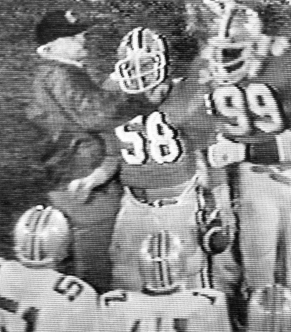 In what has become known as 'The Punch," this image taken from an ABC video image shows legendary Ohio State coach Woody Hayes, left, slugging Clemson's Charlie Bauman (58) after his interception of an Art Schlichter pass sealed the Tigers' victory in the Gator Bowl in 1978.