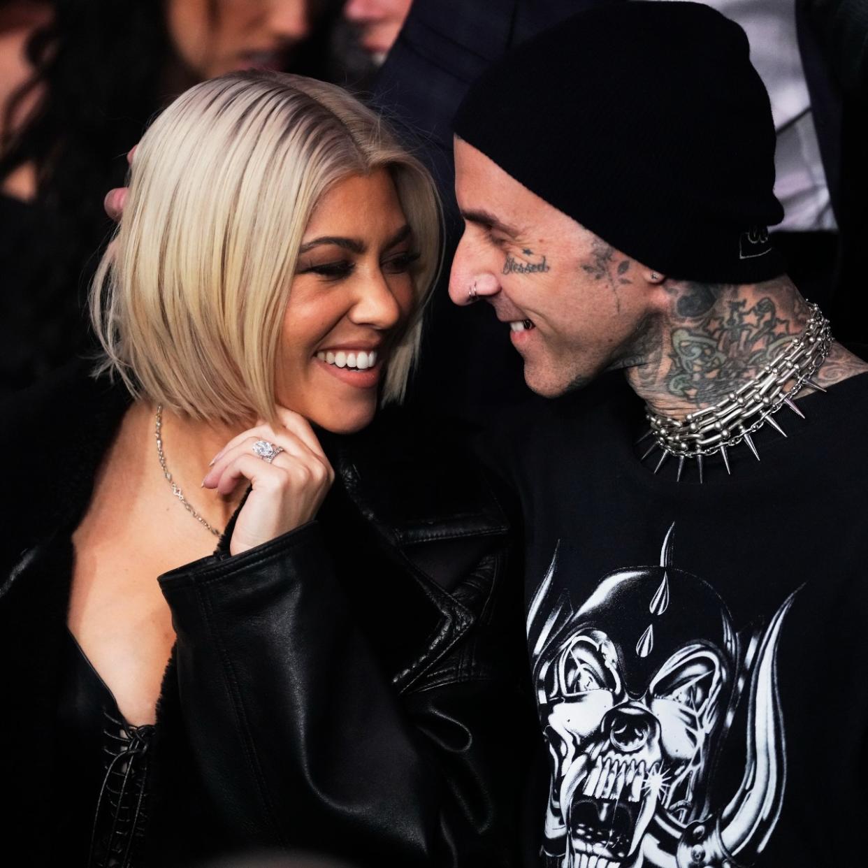  Kourtney Kardashian Barker and Travis Barker stare lovingly at one another. 