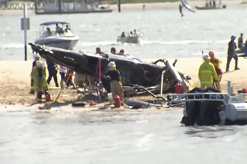 This image from a video shows a crashed helicopter on Gold Coast, Australia Monday, Jan. 2, 2023. Two helicopters collided Monday afternoon over the Australian beach. (CH9 via AP)