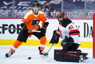 New Jersey Devils' Scott Wedgewood, right, blocks a shot as Philadelphia Flyers' Wade Allison looks for the rebound during the second period of an NHL hockey game, Monday, May 10, 2021, in Philadelphia. (AP Photo/Matt Slocum)