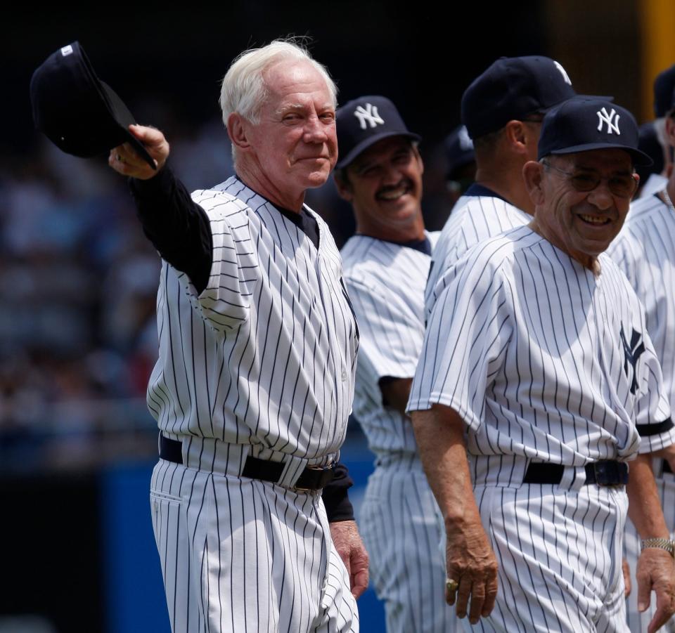 Whitey Ford, left, acknowledging the crowd as Yogi Berra, right looks on before the Old Timers game at Yankee Stadium in New York, 2007 - Julie Jacobson/AP Photo