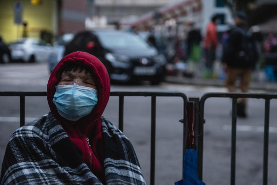  A customer sleeps while waiting for a store selling face masks to open. Thousands of Hong Kong residents waited overnight for a store selling face masks to open. Customers were only allowed to purchase two packs of masks per person. Some customers ended up waiting for over 20 hours for the store to open. (Photo by Aidan Marzo / SOPA Images/Sipa USA) 