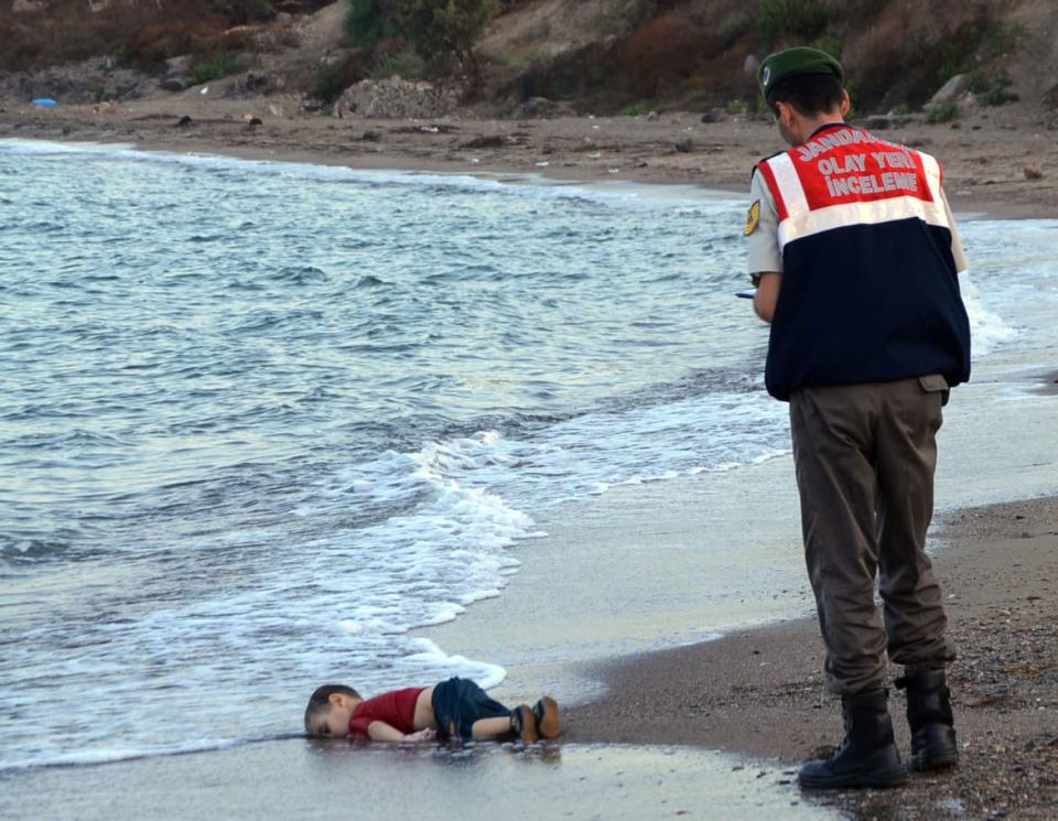 <div class="inline-image__caption"><p>A paramilitary police officer investigated the scene before carrying the body of 3-year-old Syrian refugee Aylan Kurdi from the sea shore, near the beach resort of Bodrum, Turkey, on Sept. 2, 2015.</p></div> <div class="inline-image__credit">Nilufer Demir/DHA via AP</div>