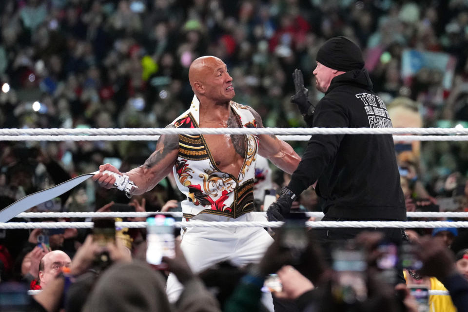 The Rock and The Undertaker interfere with the WWE Universal Championship match between Roman Reigns and Cody Rhodes during Wrestlemania XL Sunday in Philadelphia. (Joe Camporeale-USA TODAY Sports)