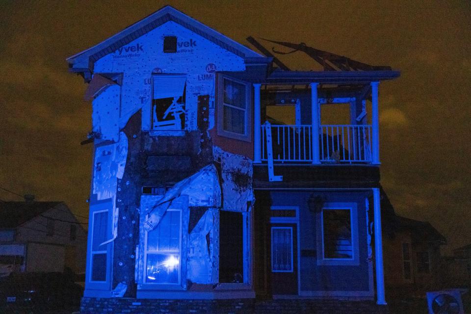 An evening view of a home that was destroyed by a tornado.