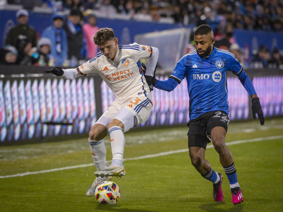 FC Cincinnati's Luca Orellano, left, fights to keep the ball from CF Montreal's Ruan during the first half of an MLS soccer match Saturday, April 13, 2024, in Montreal. (Peter McCabe/The Canadian Press via AP)