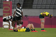 Australia's Charlotte Caslick, center, and Maddison Levi react after their team lost to Fiji in their women's rugby sevens quarterfinal match at the 2020 Summer Olympics, Friday, July 30, 2021 in Tokyo, Japan. (AP Photo/Shuji Kajiyama)