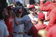 Cincinnati Reds' Nick Lodolo is greeted with high-fives in the dugout during the sixth inning of a baseball game against the Chicago White Sox, Saturday, April 13, 2024, in Chicago. (AP Photo/Melissa Tamez)