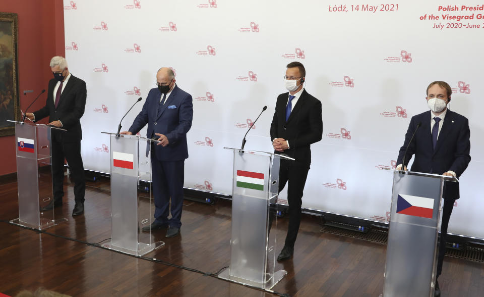 Slovak Foreign Minister Ivan Korcok, left, Polish Foreign Minister Zbigniew Rau, Hungarian Foreign Minister Peter Szijjarto and Czech Republic Foreign Minister Tomas Petricek,right, during a press conference after the foreign ministers of the Visegrad Group ,V4, in Lodz, Poland, Friday, May 14, 2021.( AP Photo/Czarek Sokolowski)