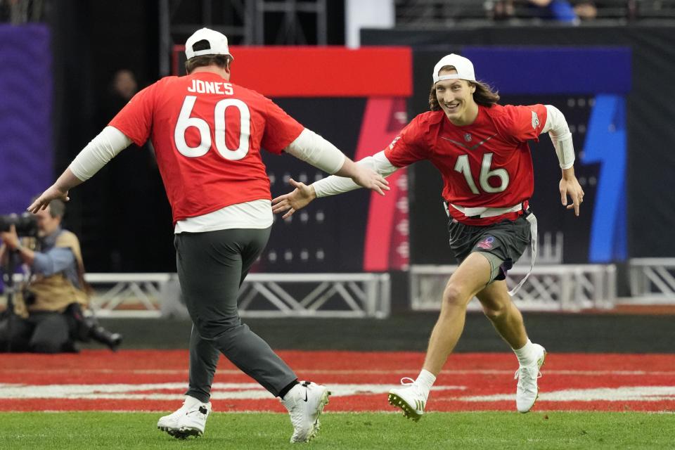 AFC quarterback Trevor Lawrence (16) of the Jacksonville Jaguars high fives AFC center Ben Jones (60) of the Tennessee Titans during the flag football event at the Pro Bowl Games, Sunday, Feb. 5, 2023, in Las Vegas. (Doug Benc/AP Images for NFL)