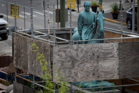 A monument to Confederate General John Hunt Morgan stands encased in a protective scaffolding because of local construction, outside the Historic Lexington Courthouse in Lexington, Ky., U.S., August 15, 2017.  REUTERS/Bryan Woolston