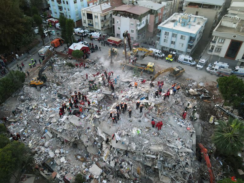 An aerial view shows rescue workers searching for survivors at a collapsed building after an earthquake in Izmir