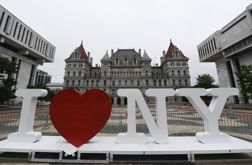 FILE - In this Tuesday, June 18, 2019, file photo, a new promotional "I Love NY" sign sits in the Empire State Plaza for installation in front of the New York state Capitol in Albany, N.Y. Milton Glaser, the designer who created the “I (HEART) NY” logo and the famous Bob Dylan poster with psychedelic hair, died Friday, June 26, 2020, his 91st birthday. (AP Photo/Hans Pennink, File)