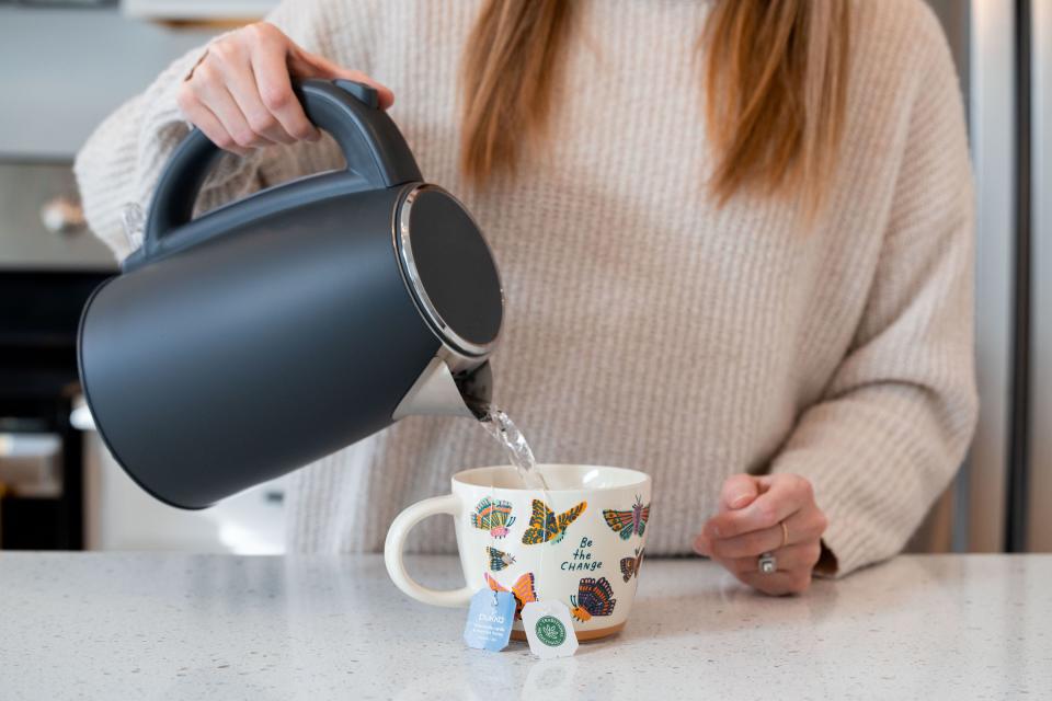 Lauren Hess pours hot water for a cup of tea at her home in Syracuse on Saturday, Jan. 6, 2024. Hess has worked to make her home cozy and to appreciate unique aspects of the season in an effort to boost her mood during the winter. | Megan Nielsen, Deseret News