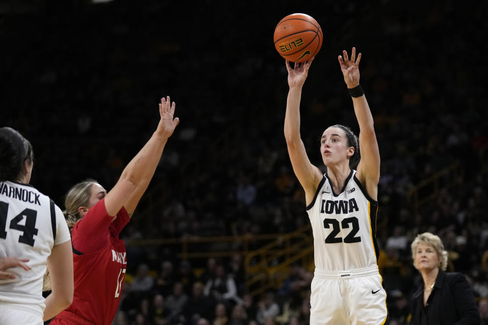 Iowa guard Caitlin Clark (22) shoots a 3-point basket over Maryland guard Faith Masonius during the second half of an NCAA college basketball game, Thursday, Feb. 2, 2023, in Iowa City, Iowa. Iowa won 96-82. (AP Photo/Charlie Neibergall)