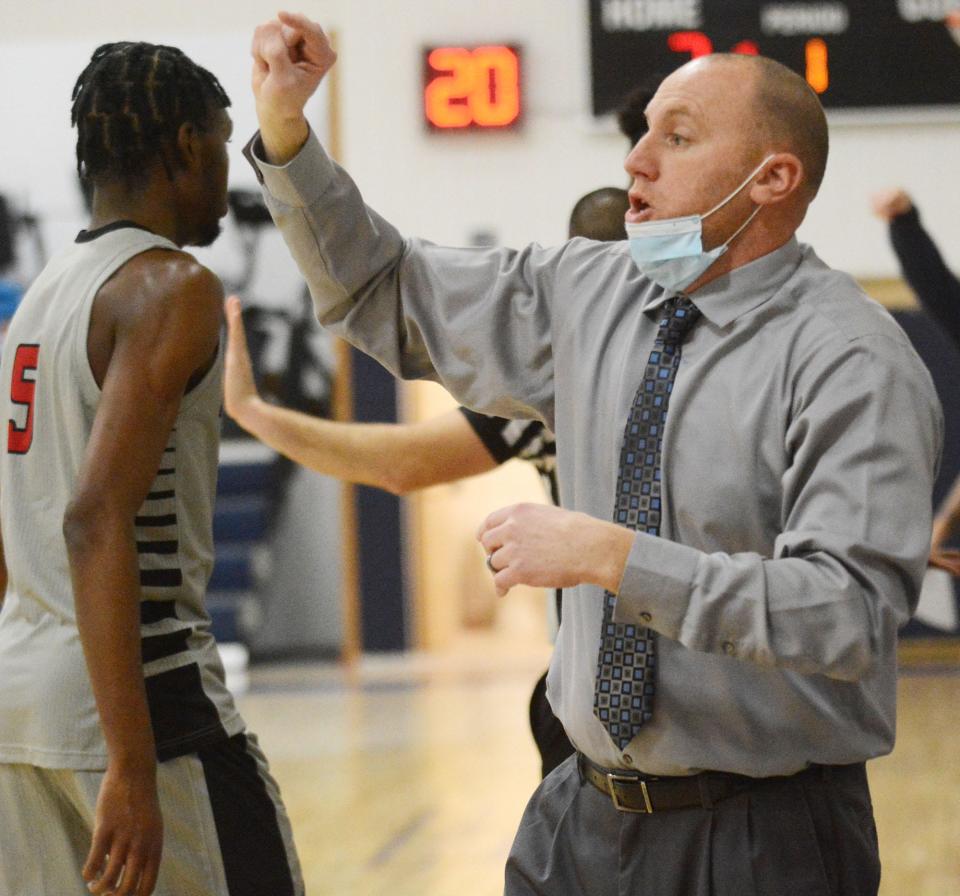 Putman Science Academy coach Tom Espinosa directs his team during the Mustangs' 81-69 win over St. Thomas More last season in Oakdale.