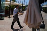 A waiter clears the table in a restaurant in Lisbon