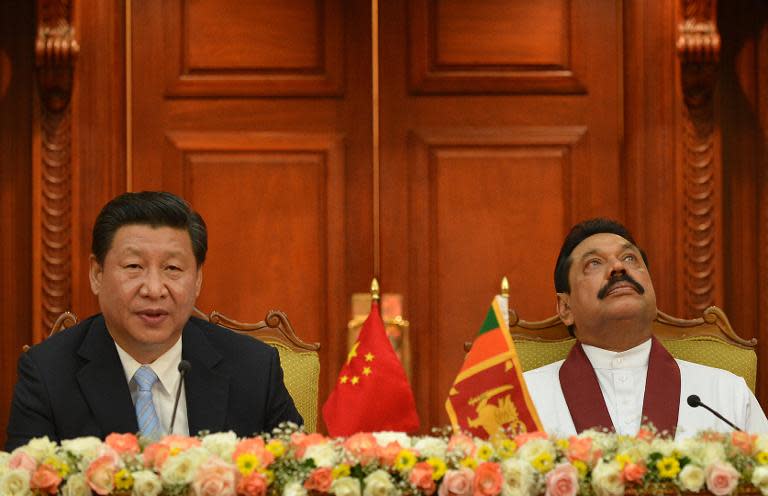 China's President Xi Jinping (L) delivers a speech next to Sri Lankan President Mahinda Rajapaksa, during a meeting at the Presidential Secretariat in Colombo, on September 16, 2014