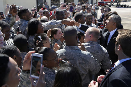 U.S. President Barack Obama (R) greets soldiers as he arrives aboard Air Force One at Maxwell Air Force Base in Montgomery, Alabama, March 7, 2015. REUTERS/Jonathan Ernst