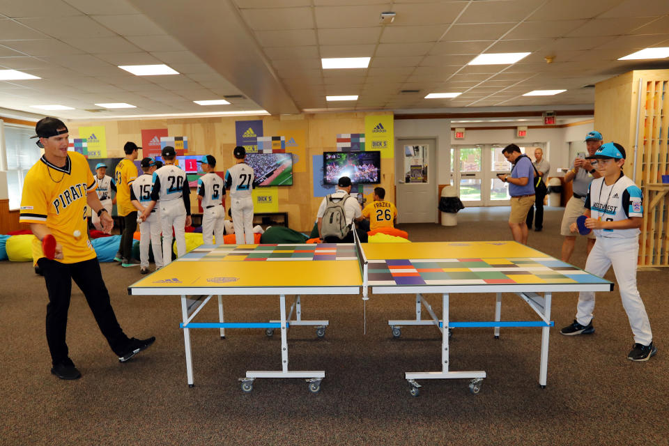 Kevin Newman of the Pittsburgh Pirates plays ping pong with Andrew Mhoon of the Northwest team in the game room at the Grove at the Little League complex prior to the 2019 Little League Classic between the Chicago Cubs and the Pittsburgh Pirates.