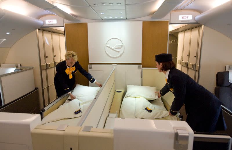 FILE PHOTO: Flight attendants pose as they prepare beds of First in new Airbus A380 aircraft for Lufthansa before hand-over ceremony at manufacturer's site in Finkenwerder, near Hamburg
