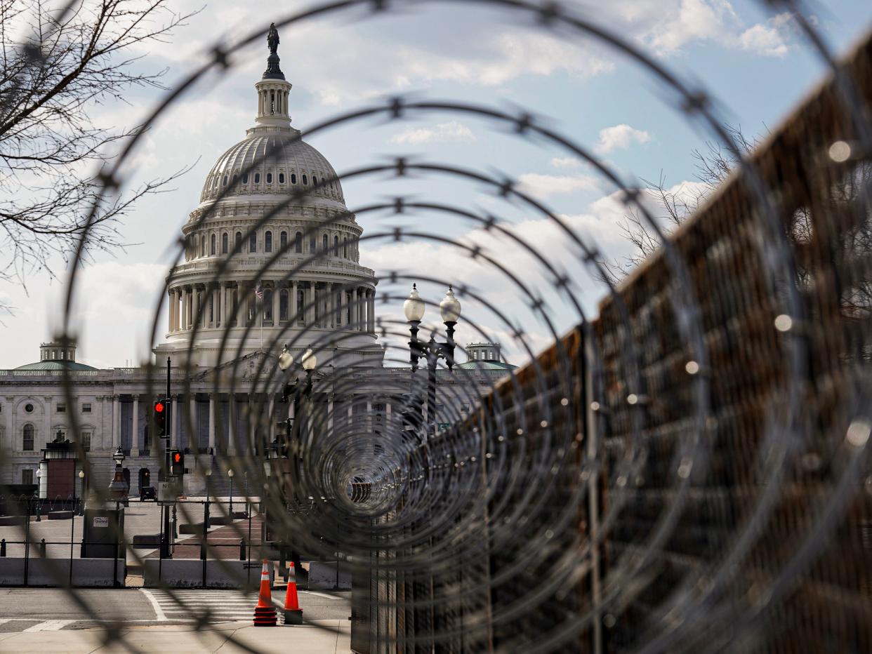 <p>The US Capitol is seen through razor wire after police warned that a militia group might try to attack the US Capitol in Washington, US, 4 March, 2021</p> (REUTERS)