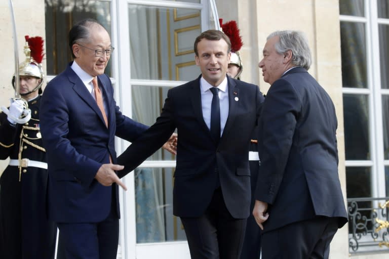 French President Emmanuel Macron (C) welcomes World Bank President Jim Yong Kim (L) and UN Secretary General Antonio Guterres before their meeting at the Elysee Palace in Paris as part of the One Planet Summit on December 12, 2017